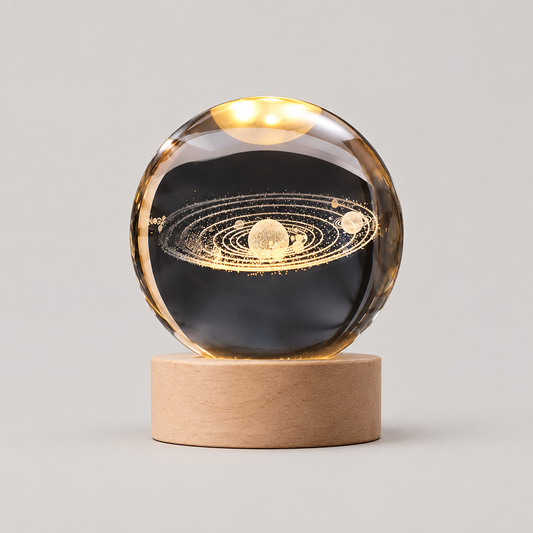 3D Engraved Glass Crystal Ball Night Light with Wood Base on a neutral background