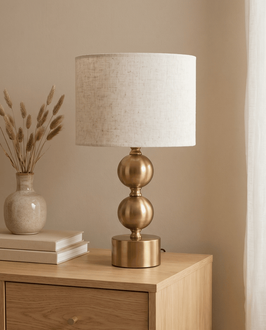 Gold metal orb table lamp with linen shade