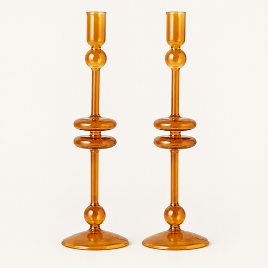 Amber Glass Taper Candlesticks, Set of 2 on a plain off-white background