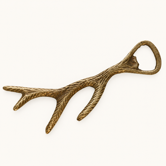Brass-Plated Antler Bottle Opener on a plain off-white background