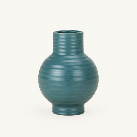 Ribbed Ceramic Vase in Blue on a plain off-white background