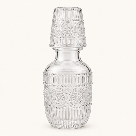 Embossed Glass Bedside Carafe with Cup on a plain off-white background